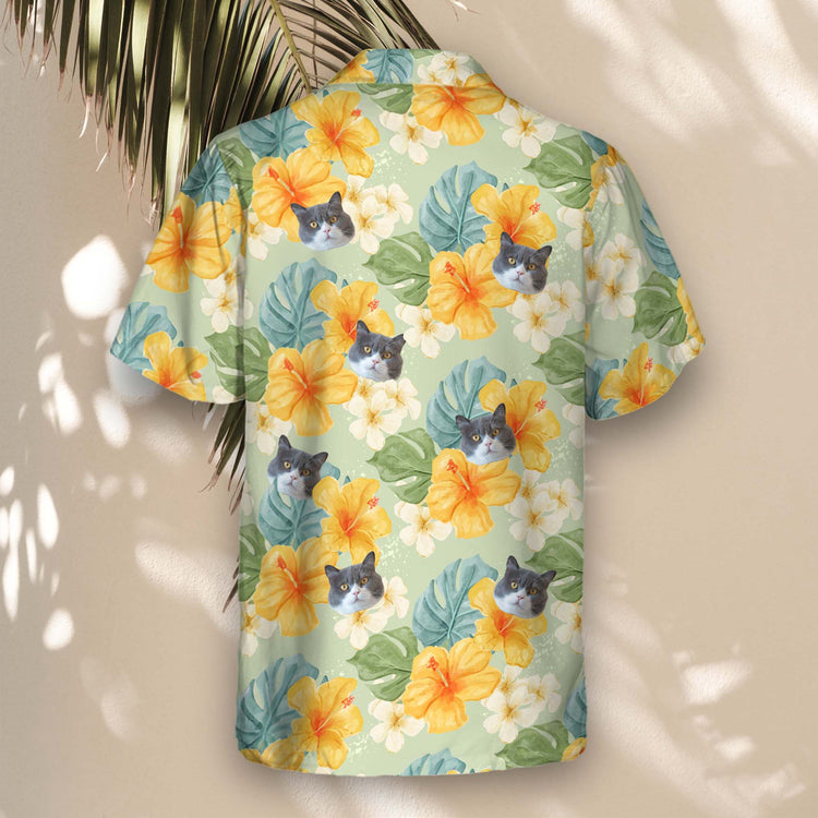 Tropical custom Hawaiian shirts with yellow hibiscus and plants on a light green backdrop. Personalize with faces on them for a fun, laid-back vibe.