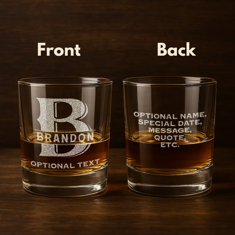 Custom whiskey glass etched with a monogram, filled with whiskey shown against a rustic wooden background for a masculine aesthetic.
