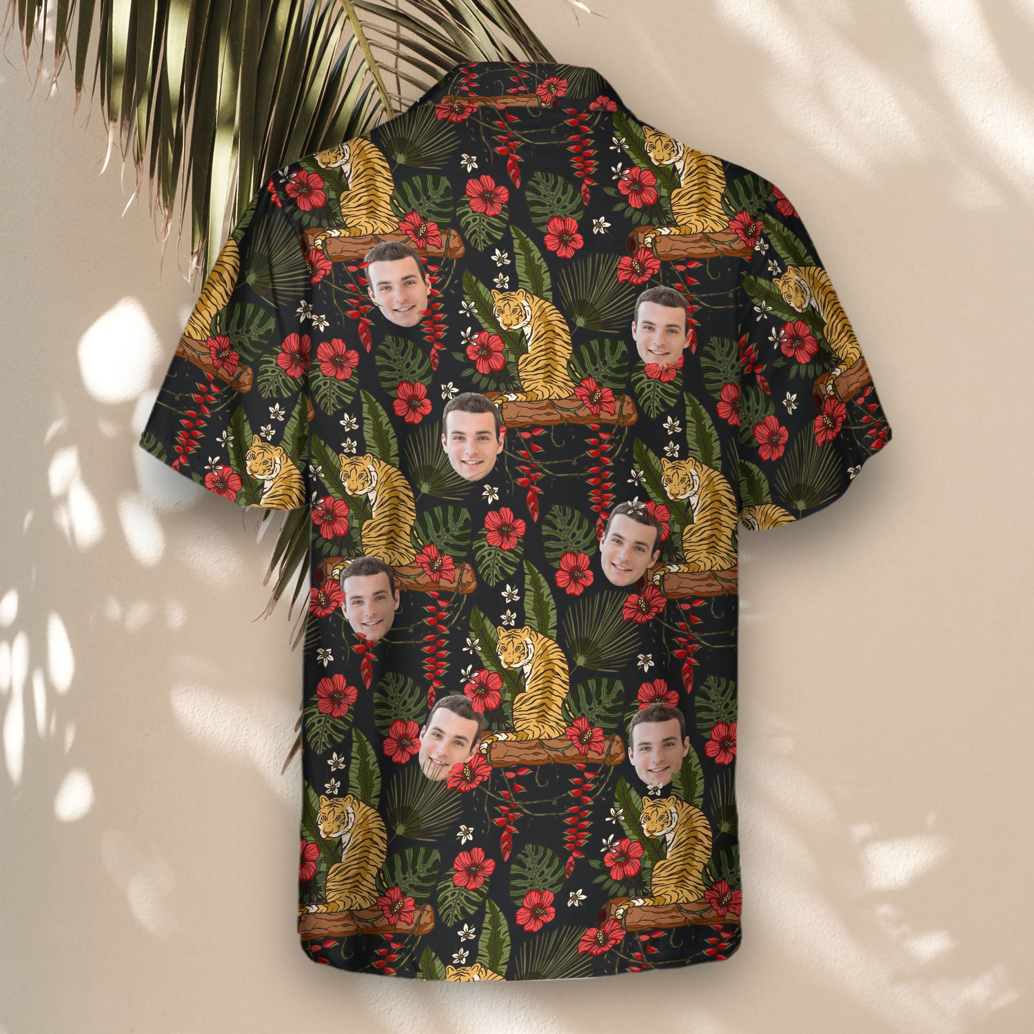 Custom Hawaiian shirts with faces on them, featuring a fierce jungle tiger, green palm leaves, and red hibiscus flowers on a bold black background.