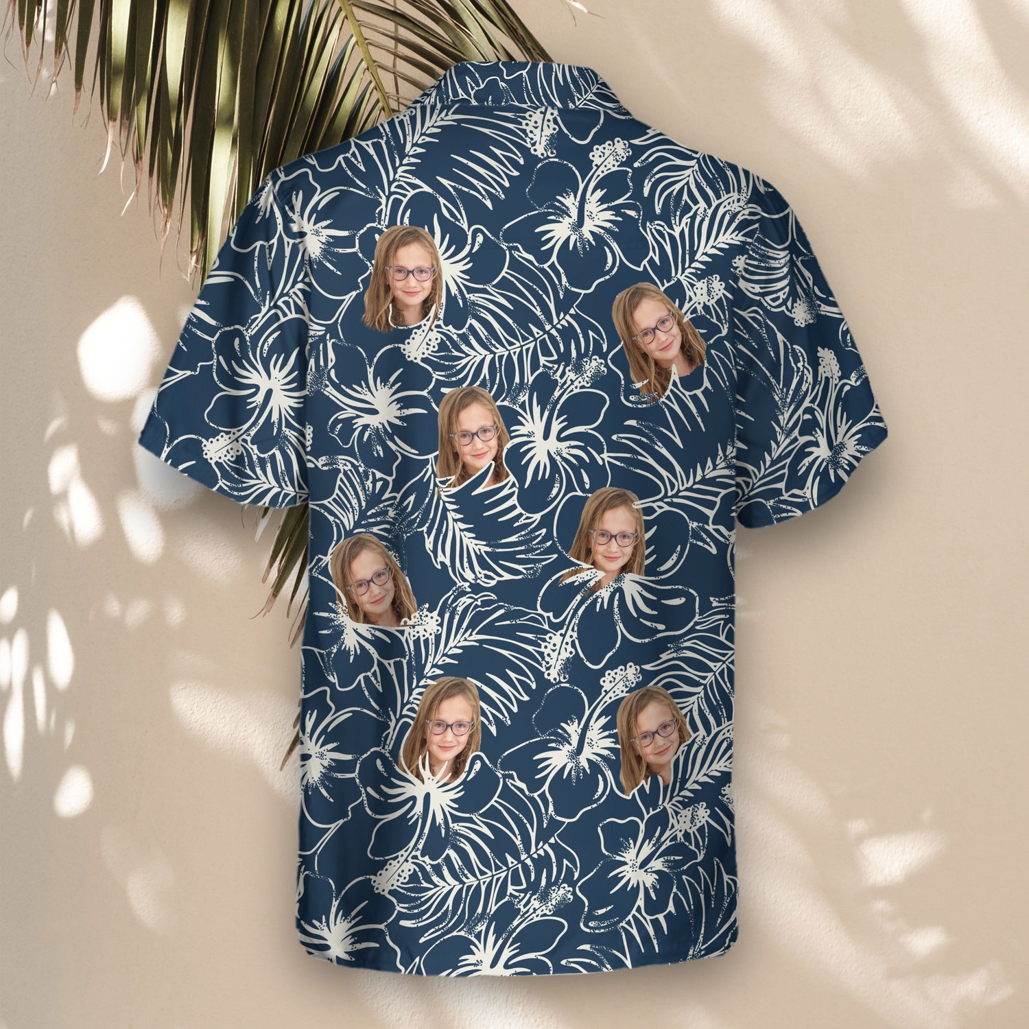 Fun custom Hawaiian shirts with faces on them, featuring vibrant hibiscus flowers and tropical plants in navy blue, perfect for a comfortable island-inspired look.