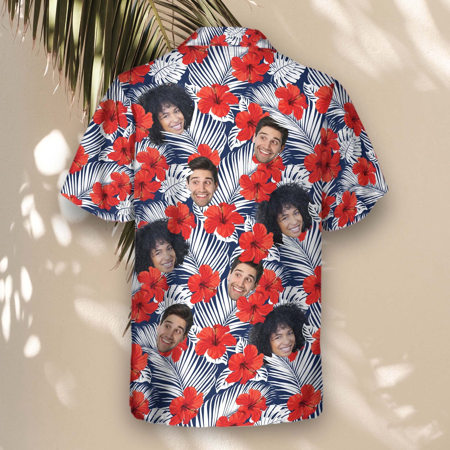 Bright and colorful custom Hawaiian shirts with faces on them, displaying tropical red flower patterns and palm leaves, perfect for beach adventures.