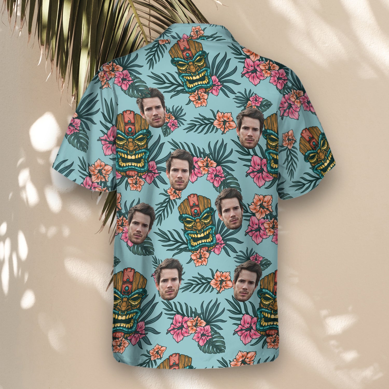 Vintage-inspired custom Hawaiian shirts with tiki masks, lush leaves, and flowers. Personalize shirts with faces on them for a fun, tropical style.