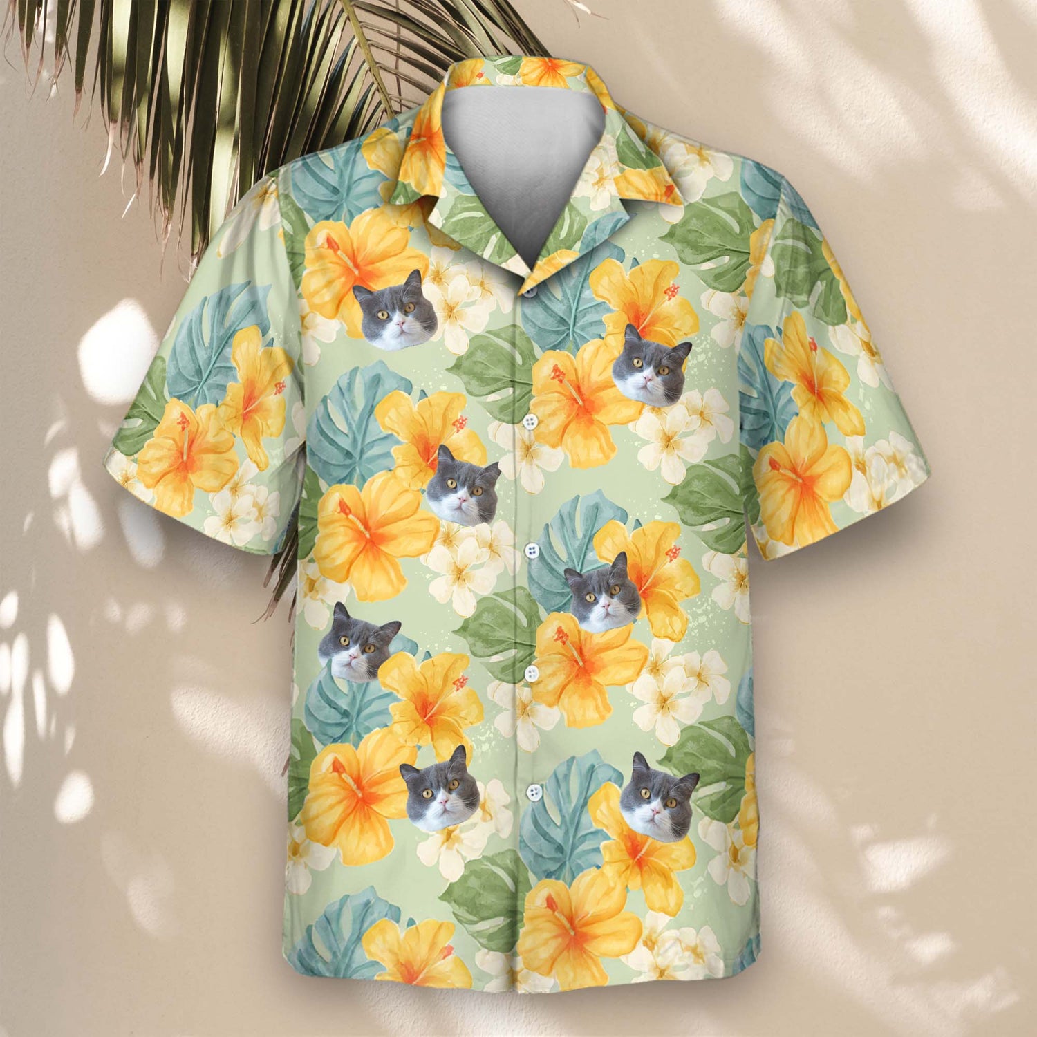 Custom Hawaiian shirts showcasing yellow hibiscus flowers and tropical foliage on light green. Add faces on them for a lightweight, cheerful look.