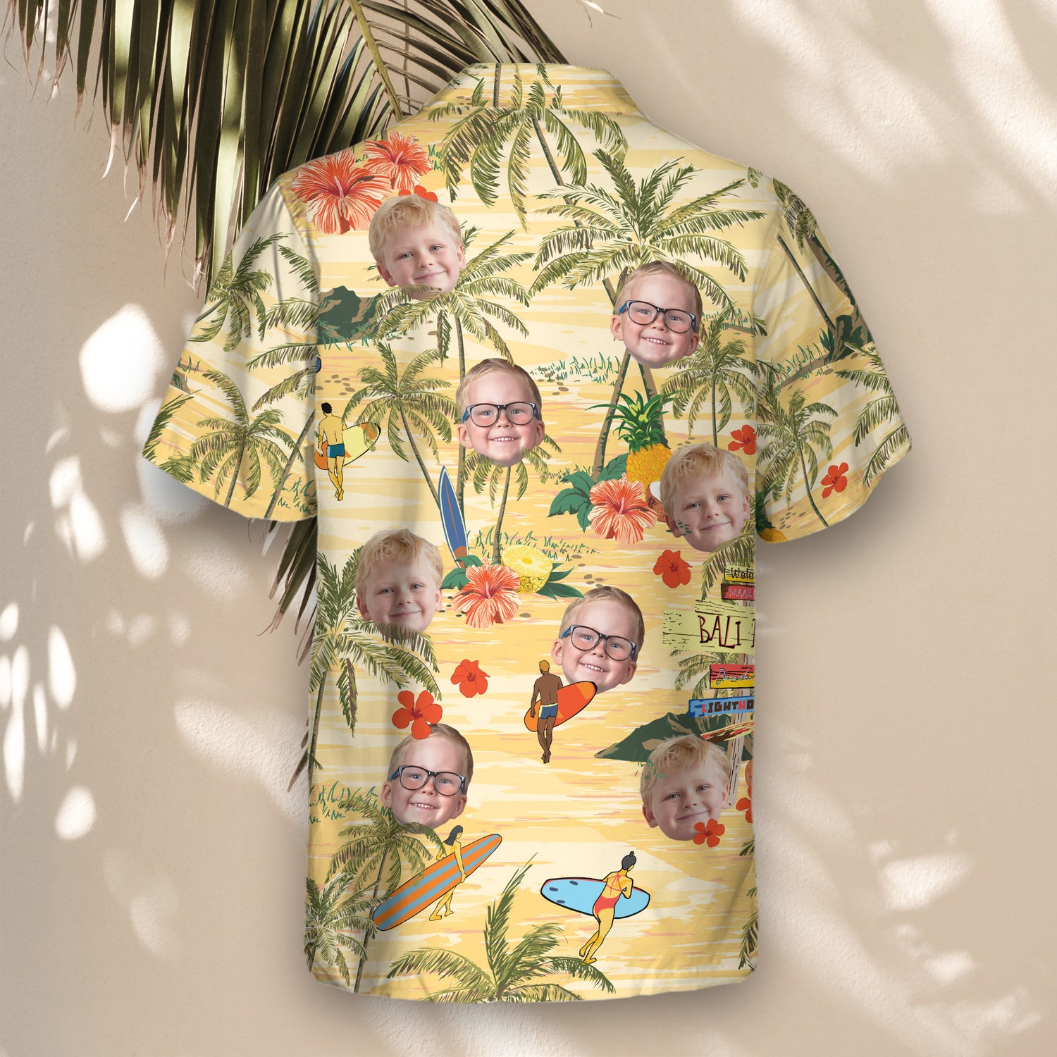 Vibrant custom Hawaiian shirts with faces on them, featuring palm trees and surfers. A light yellow backdrop brings a tropical vibe, ideal for island-inspired style.
