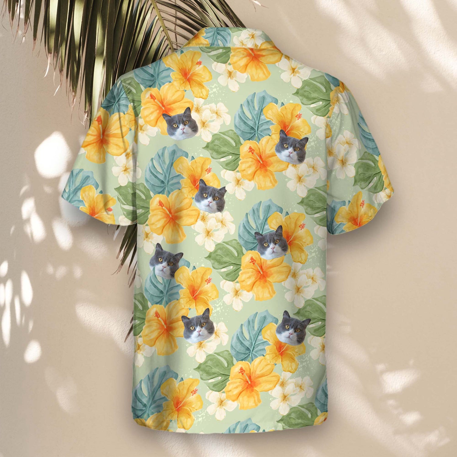 Tropical custom Hawaiian shirts with yellow hibiscus and plants on a light green backdrop. Personalize with faces on them for a fun, laid-back vibe.