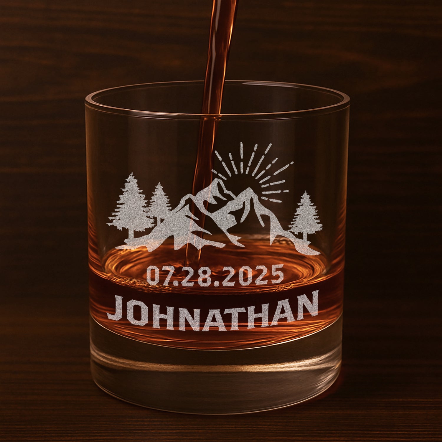 Personalized whiskey glasses with etched mountains and name.